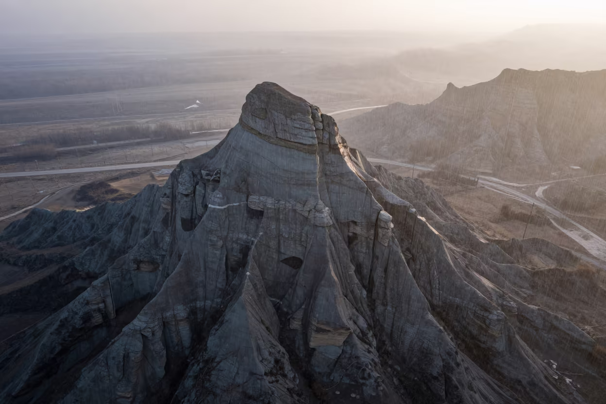 Surreal Butte Rising in Mist with Upward Rain in near Bishkek