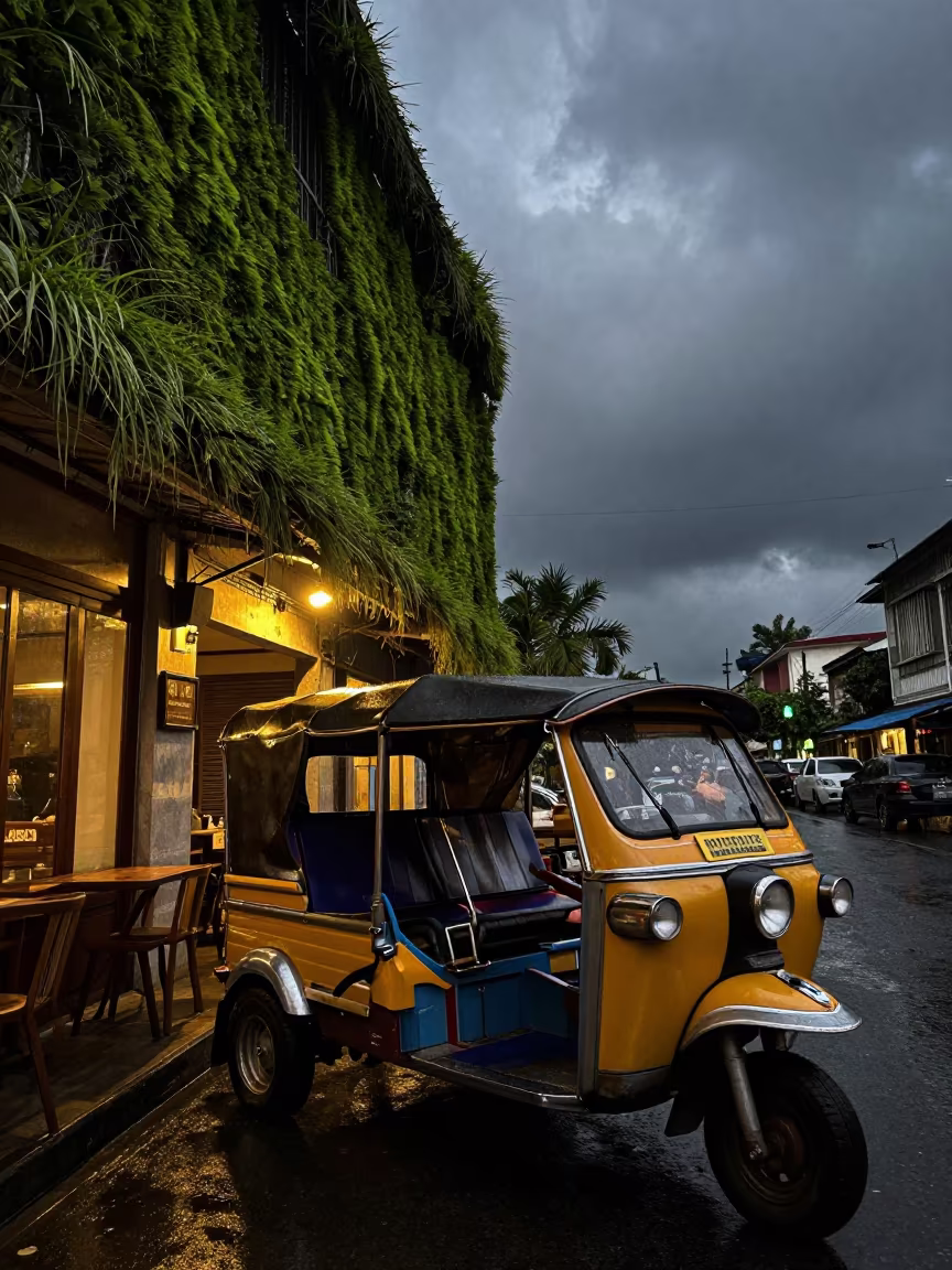 Surreal Monsoon Tuk-Tuk Night Street Phnom Penh in outside a corner cafe in Phnom Penh