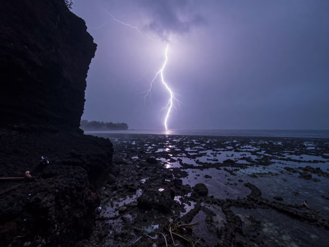Surreal Reef Lightning Before Dawn Over Denpasar in beside a volcanic reef overhang near Denpasar
