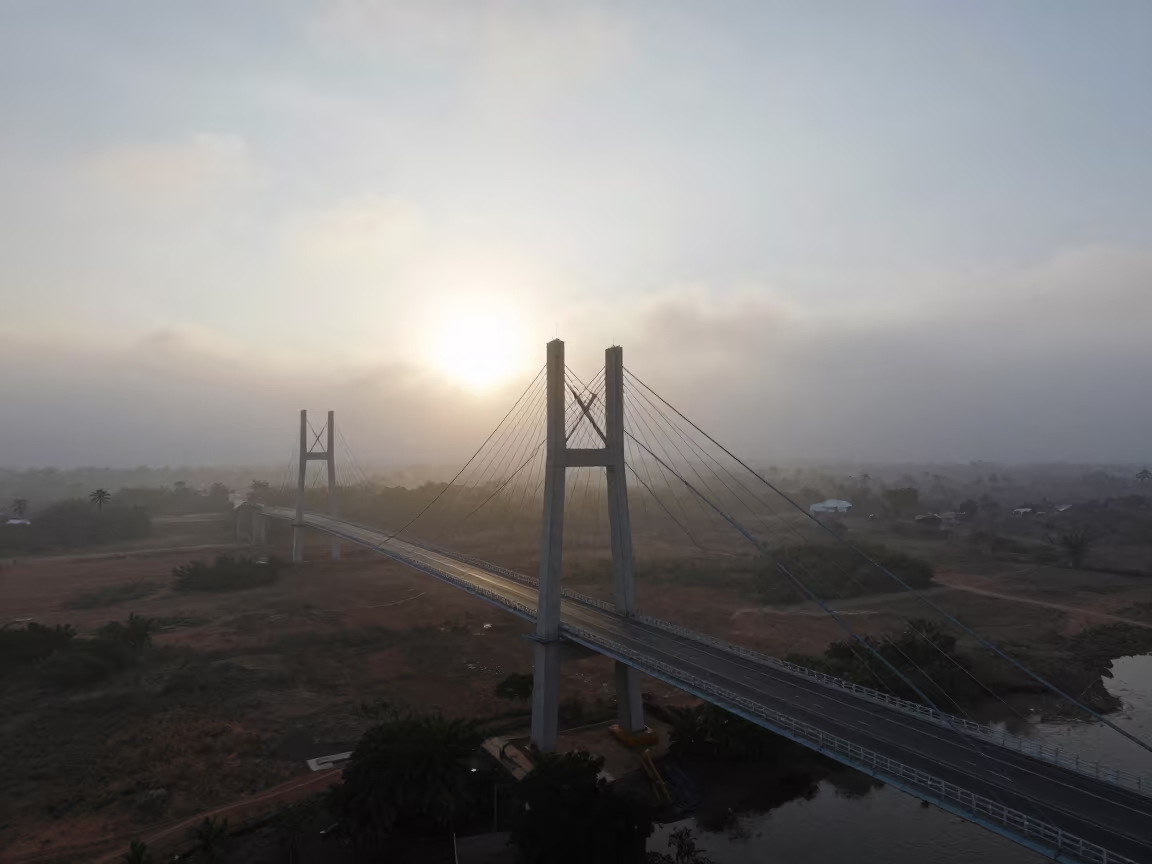 Suspension Bridge Morning Fog Equatorial Guinea in across a storm-bright plain in Equatorial Guinea