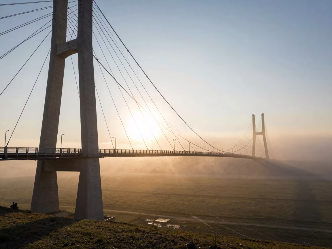 Surreal Suspension Bridge Morning Fog Kazakhstan in across a storm-bright plain in Kazakhstan