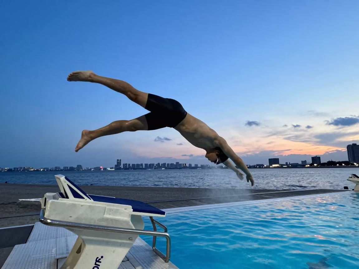 Swimmer Dives Into Indigo Twilight Pool Near Tokyo in along a beach near Tokyo