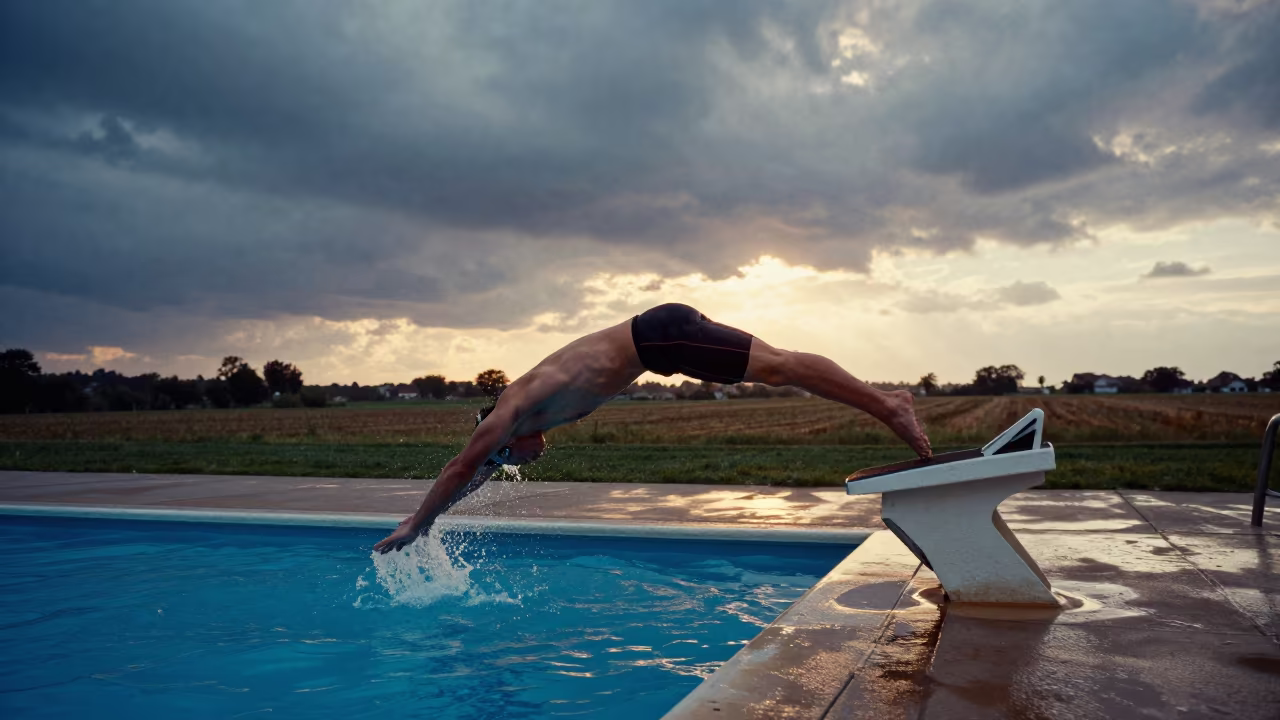 Swimmer Dives Into Pool At Sunset in near open fields near Manzanillo