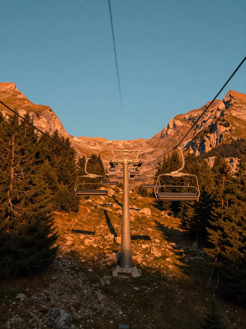 Swiss Chairlift Sunset Orange Light Alpine Switchback in along a switchback approach in Switzerland