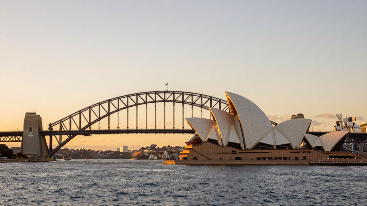 Sydney Harbor Bridge and Opera House at Sunset with City Skyline Reflections in in Sydney, New South Wales, Australia