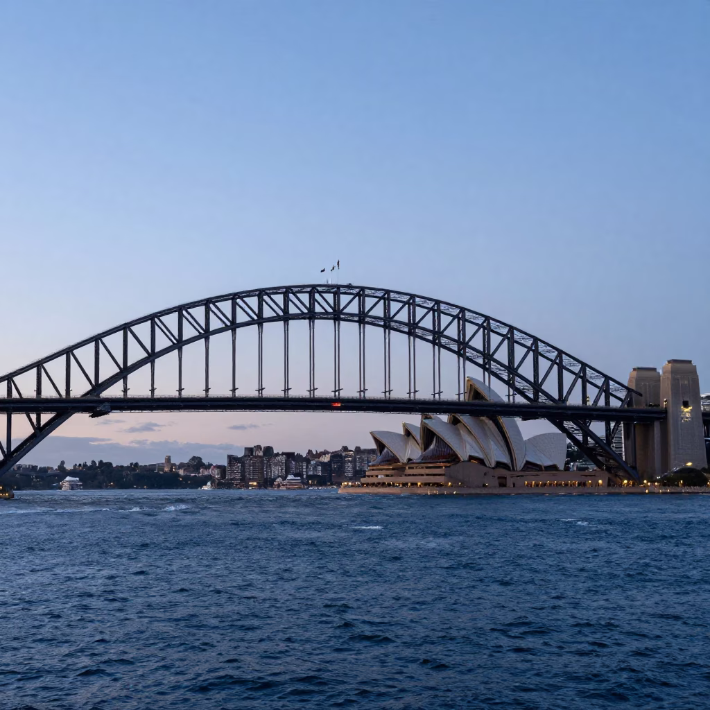 Sydney Harbour Bridge and Opera House at dusk with vintage cars and pedestrians in in Sydney, New South Wales, Australia
