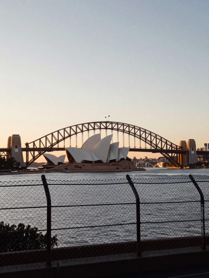 Sydney Harbour Bridge and Opera House at Nautical Dawn with Substation Fence in in Sydney, New South Wales, Australia