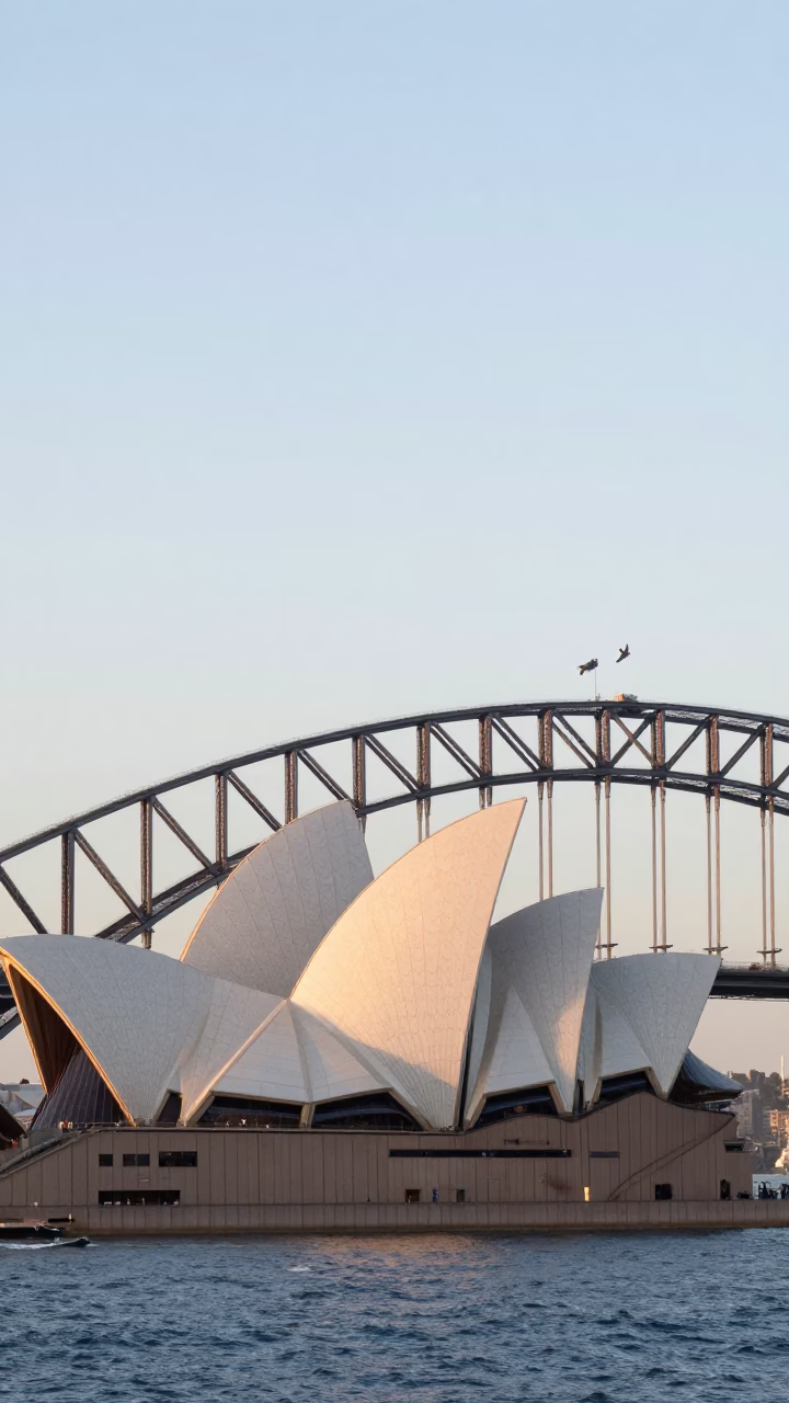 Sydney Harbour Bridge and Opera House at Sunrise with Commuters on Circular Quay Walkway in in Sydney, New South Wales, Australia