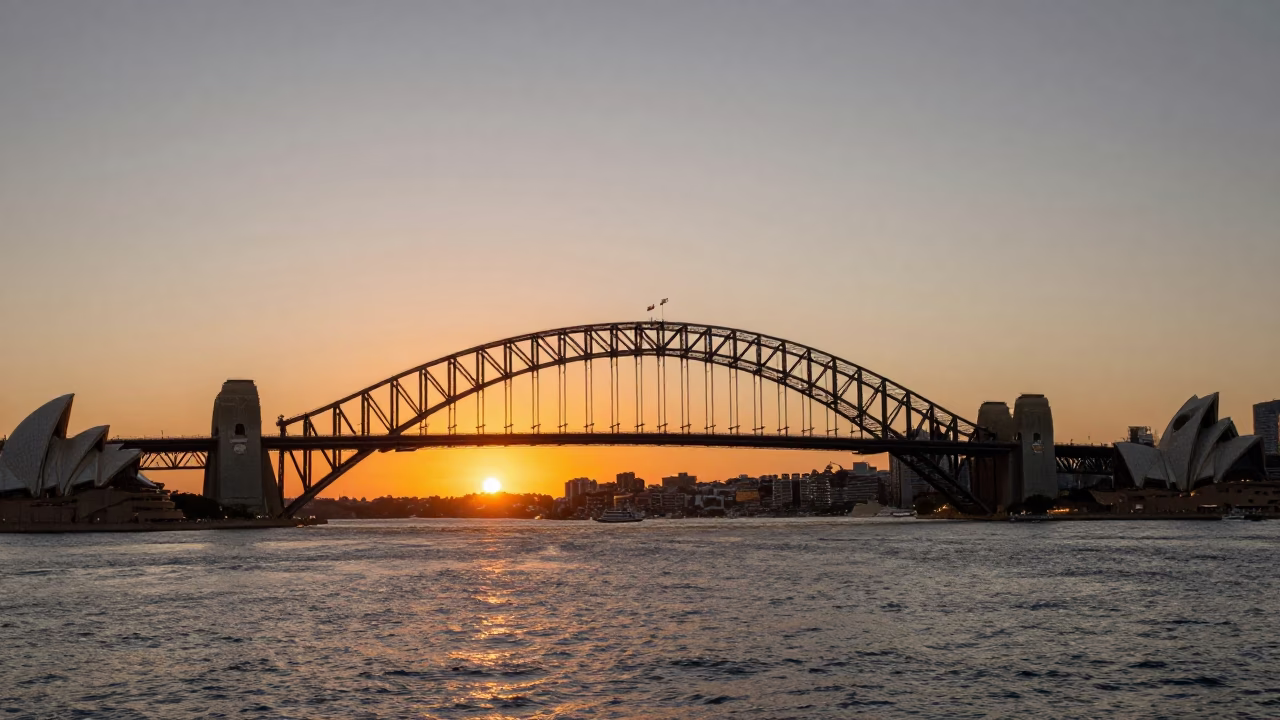 Sydney Harbour Bridge and Opera House at Sunset with Monorail and Sailboats in in Sydney, New South Wales, Australia
