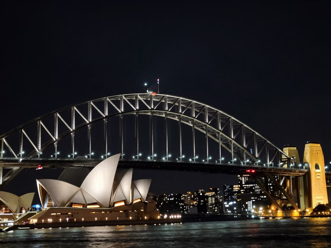 Sydney Harbour Bridge and Opera House illuminated under deep night sky with city lights in in Sydney, New South Wales, Australia