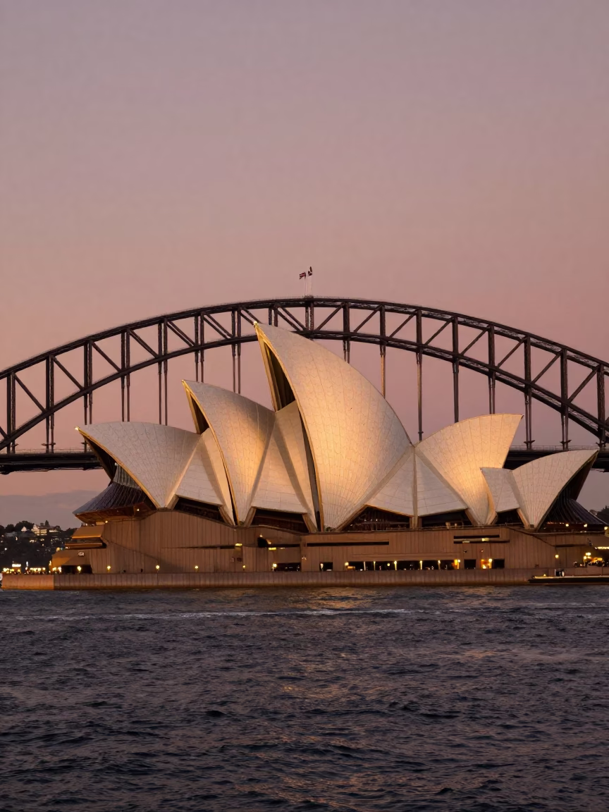 Sydney Harbour Bridge and Opera House in Copper Dusk Light with Chinese Junk Sailboat in in Sydney, New South Wales, Australia