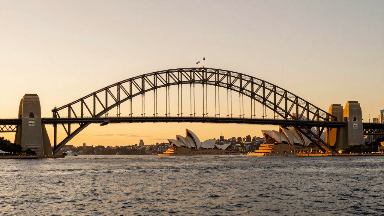 Sydney Harbour Bridge and Opera House in Honeyed Evening Light with Train Station Clock in in Sydney, New South Wales, Australia
