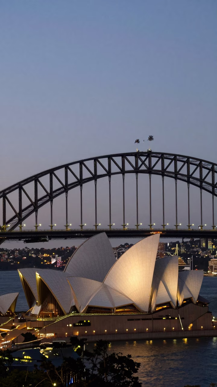 Sydney Harbour Bridge and Opera House twilight view with city lights beginning to glow in in Sydney, New South Wales, Australia