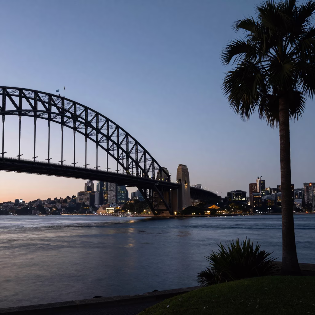 Sydney Harbour Bridge at Dawn with Palm Trees and Quiet Waterfront in in Sydney, New South Wales, Australia