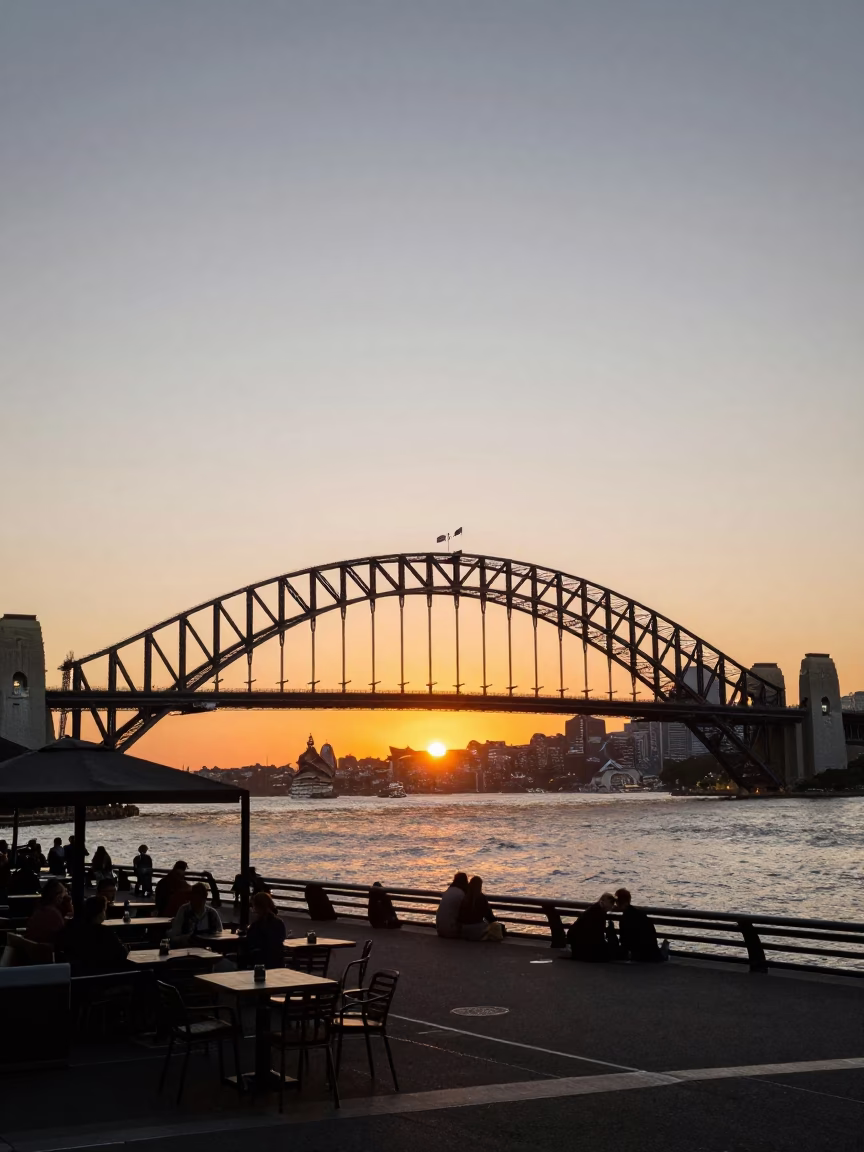 Sydney Harbour Bridge at Sunset with Local Cafe and Pedestrians in in Sydney, New South Wales, Australia