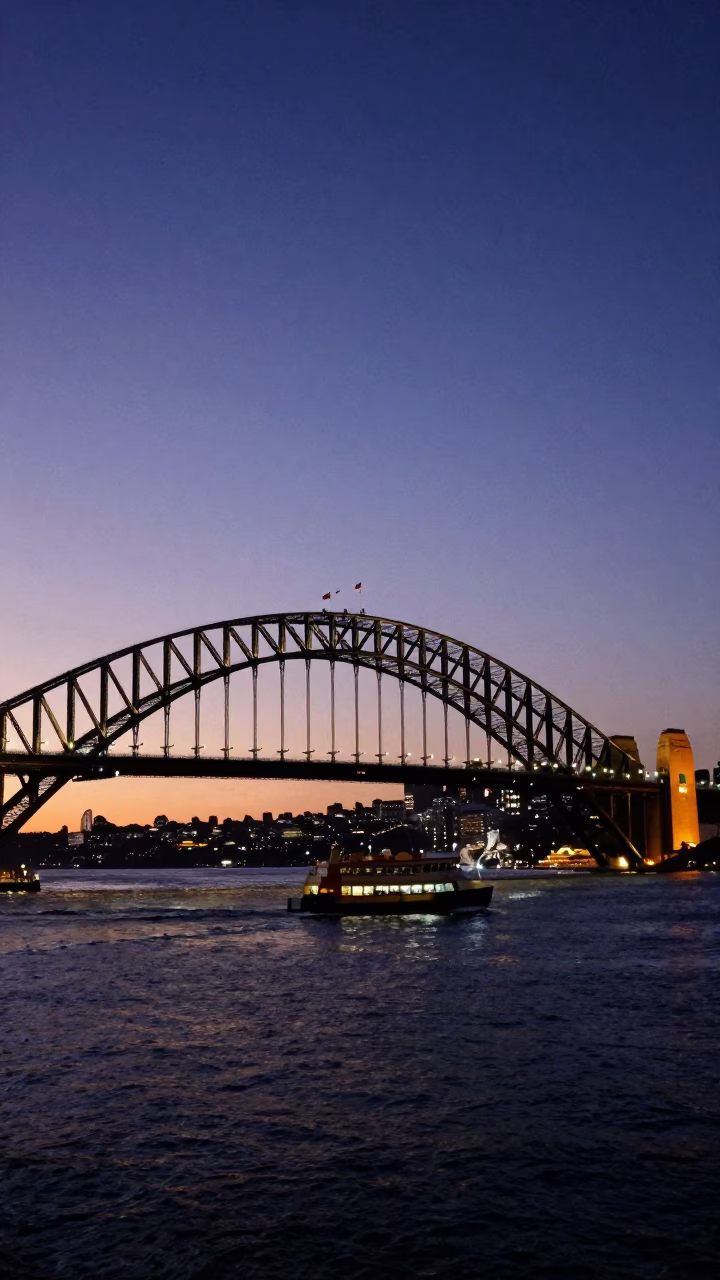 Sydney Harbour Bridge Illuminated at Indigo Twilight with Harbor Activity in in Sydney, New South Wales, Australia