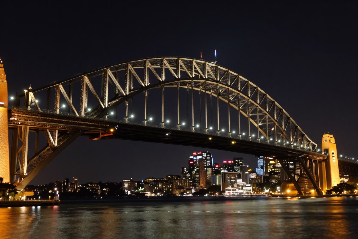 Sydney Harbour Bridge illuminated at night with city skyline and water reflections in in Sydney, New South Wales, Australia