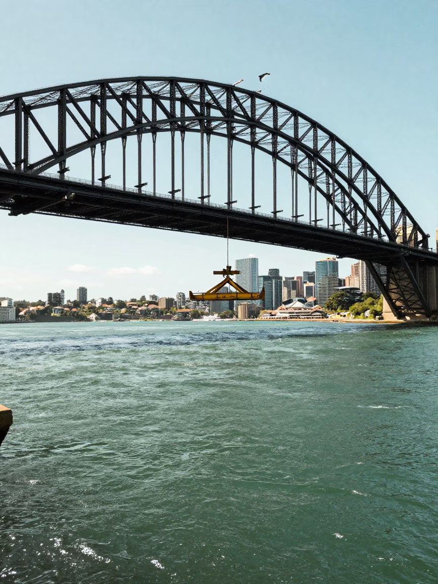 Sydney Harbour Bridge Maintenance Cradle Hanging Above Green River Water Under Flat Noon Glare in in Sydney, New South Wales, Australia