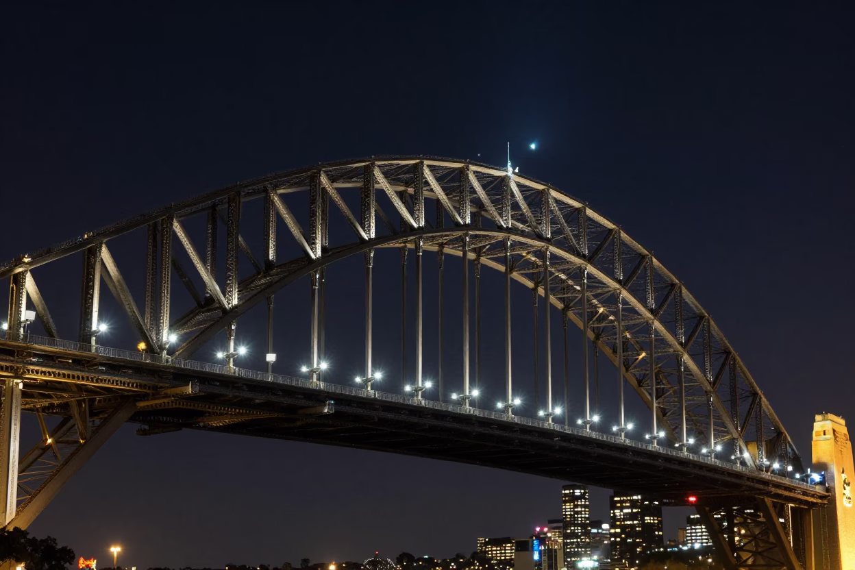 Sydney Harbour Bridge steel arches under deep night sky with city lights in in Sydney, New South Wales, Australia