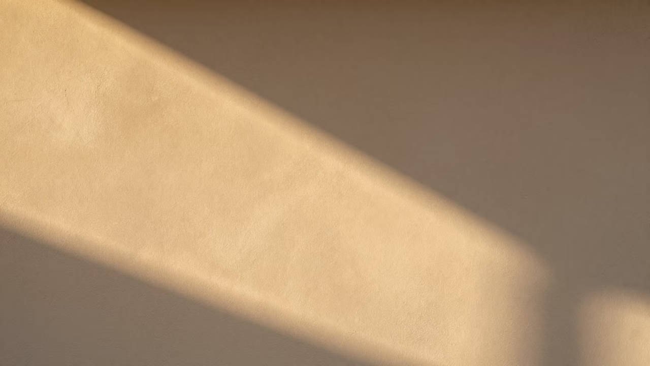 Sydney Harbour Bridge sun stripe across plaster wall honeyed evening light in in Sydney, New South Wales, Australia