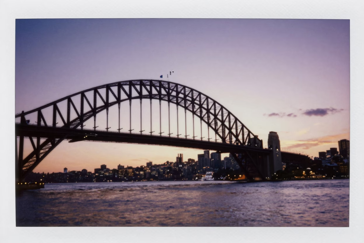 Sydney Harbour Bridge sunset view from Circular Quay with tourists and city skyline in in Sydney, New South Wales, Australia