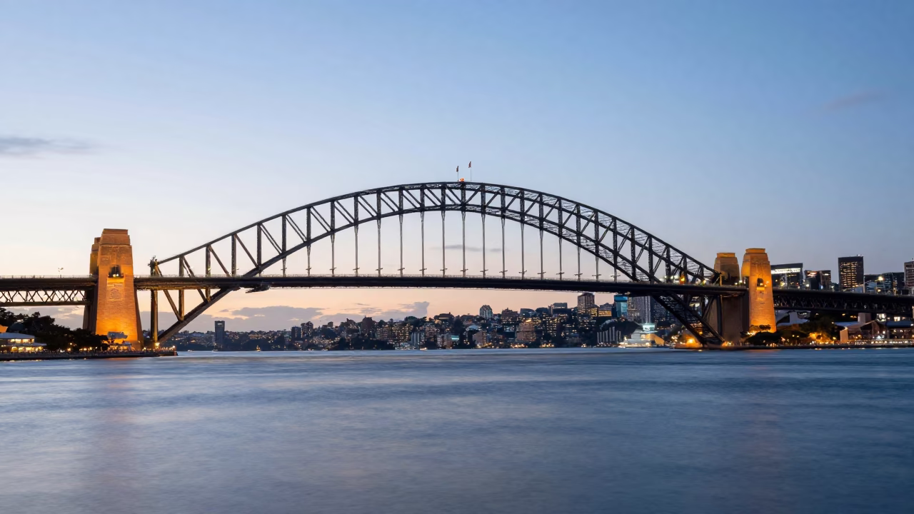 Sydney Harbour Dawn Light Illuminating Harbour Bridge and Waterfront Activity in in Sydney, New South Wales, Australia