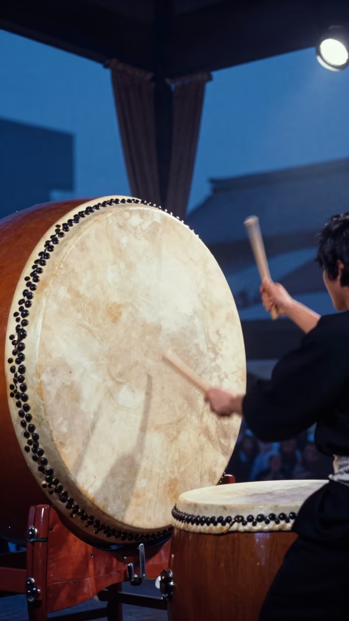 Taiko Drummer Striking Massive Drum in Tsuruhashi in at a public square during a festival in Tsuruhashi, Osaka