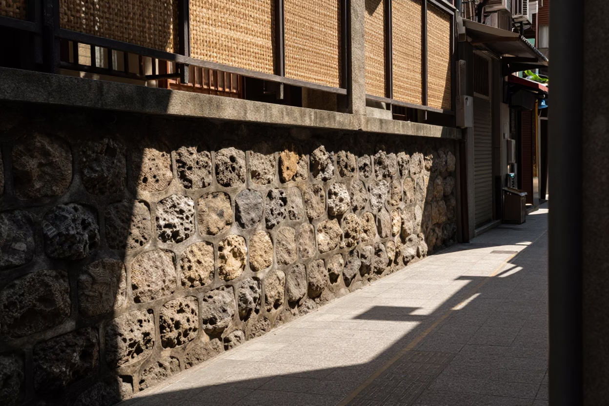 Taipei alleyway noon light through woven cane shadows on stone wall in in Taipei, Taiwan