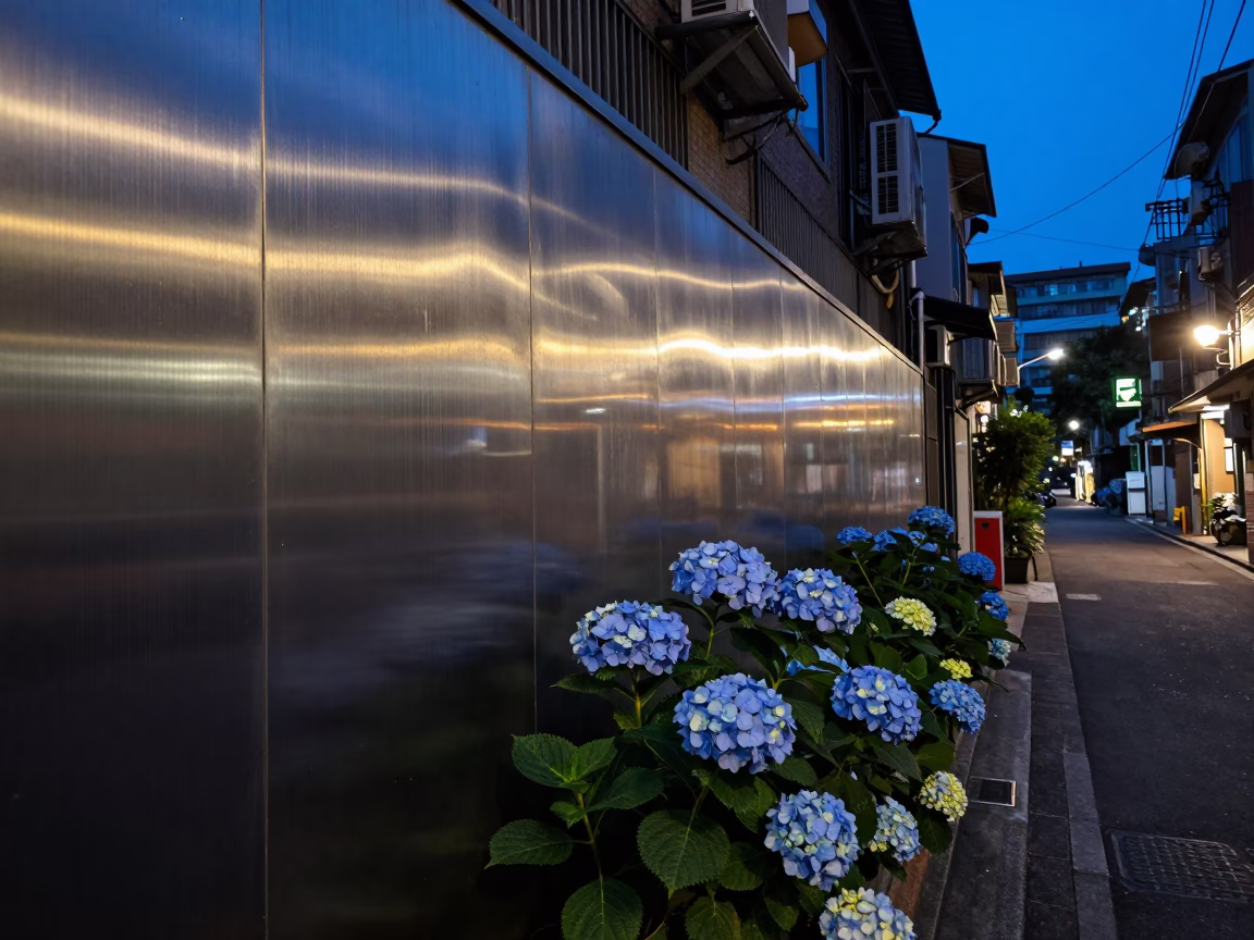 Taipei Blue Hour Street Scene with Brushed Steel Wall and Hydrangea Bush in in Taipei, Taiwan