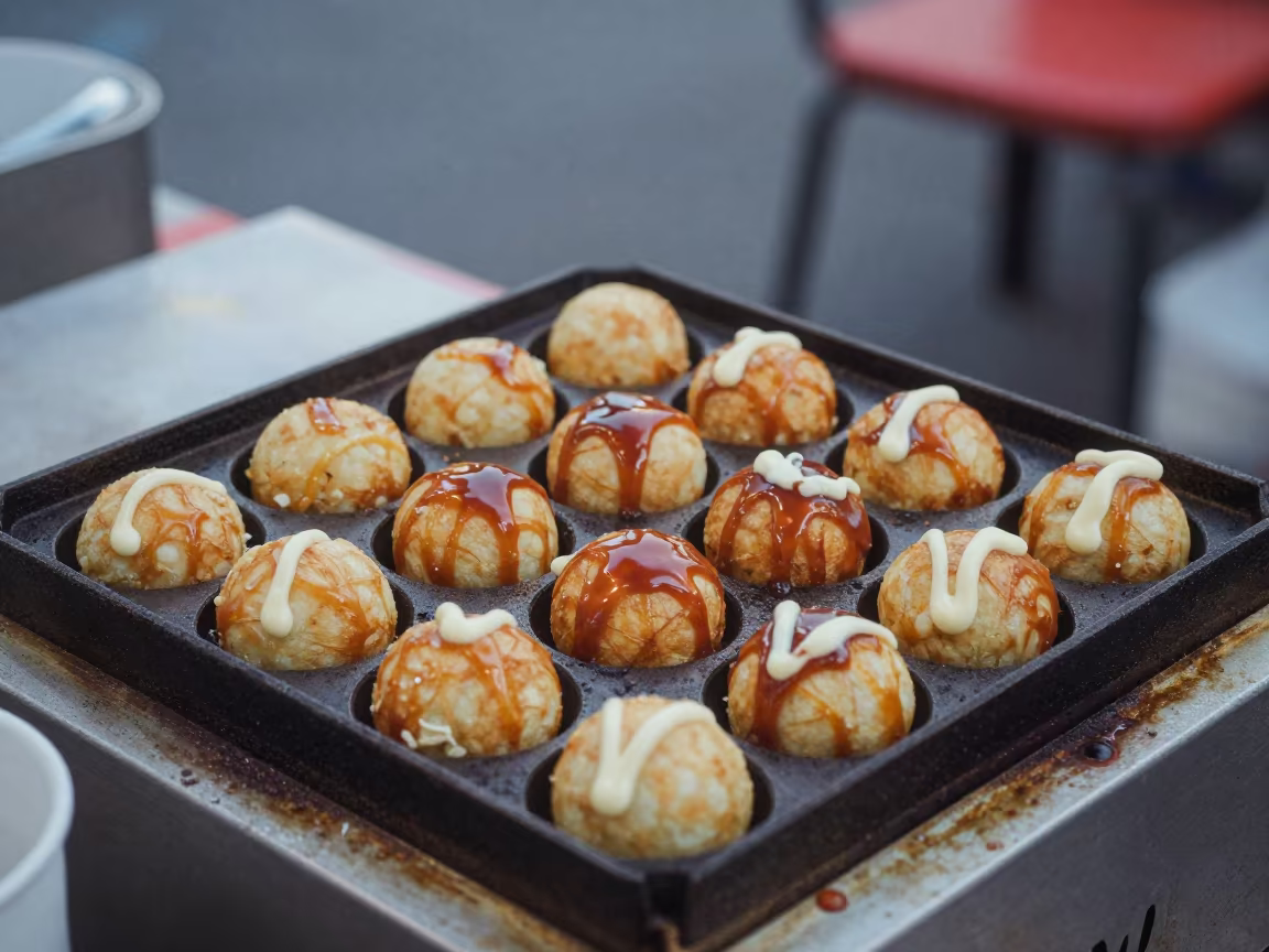Takoyaki Spheres on Grill in Osaka Diner in at a roadside diner table in Osaka