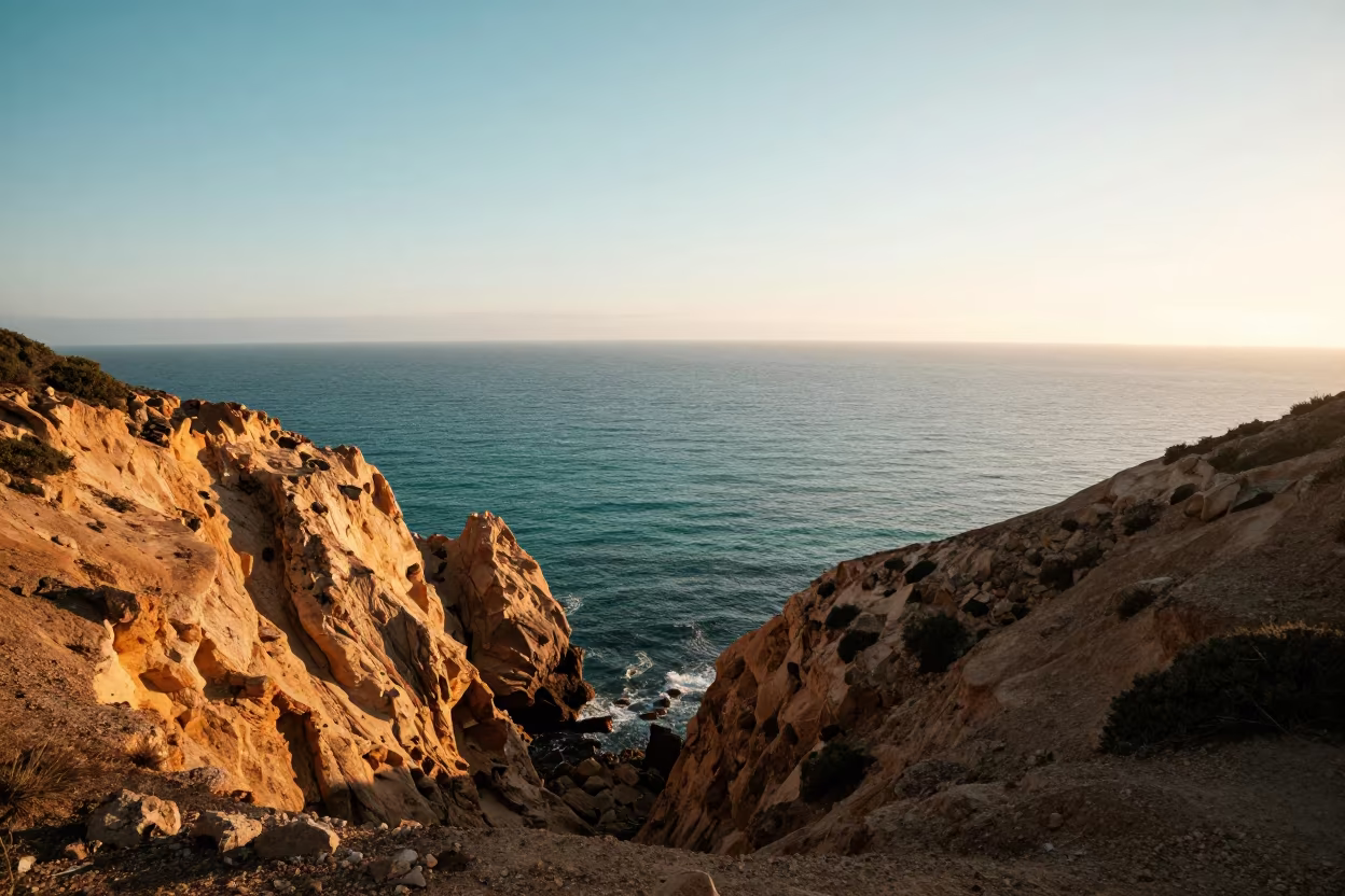 Teal Ocean Meets Ochre Cliff at Spanish Dawn in across a wide valley floor in Spain