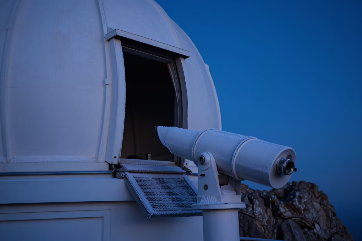 Telescope Dome Opening at Winter Twilight in along a rocky geology outcrop in North Beach, San Francisco