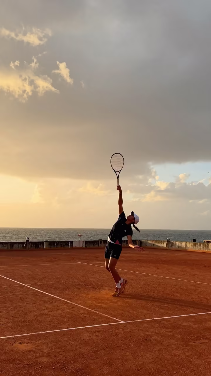 Tennis Player Serve on Harbor Quay at Sunset in at a harbor quay near Machakos