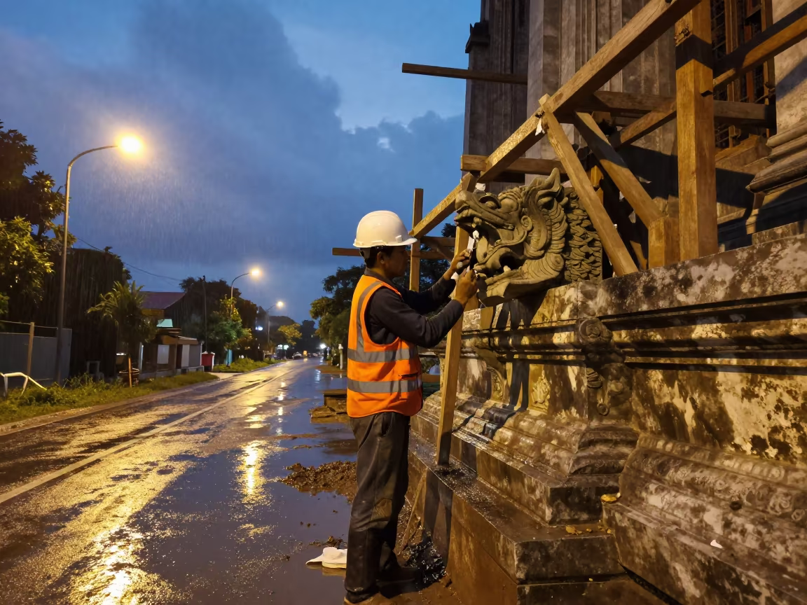 Thai Stonemason Carving Gargoyle on Cathedral Scaffold in at a muddy site access road in Thailand