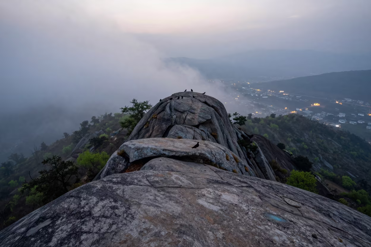 Thermal Inversion Over Thimphu Valley at Dusk in at a rocky saddle overlooking a mountain valley near Thimphu