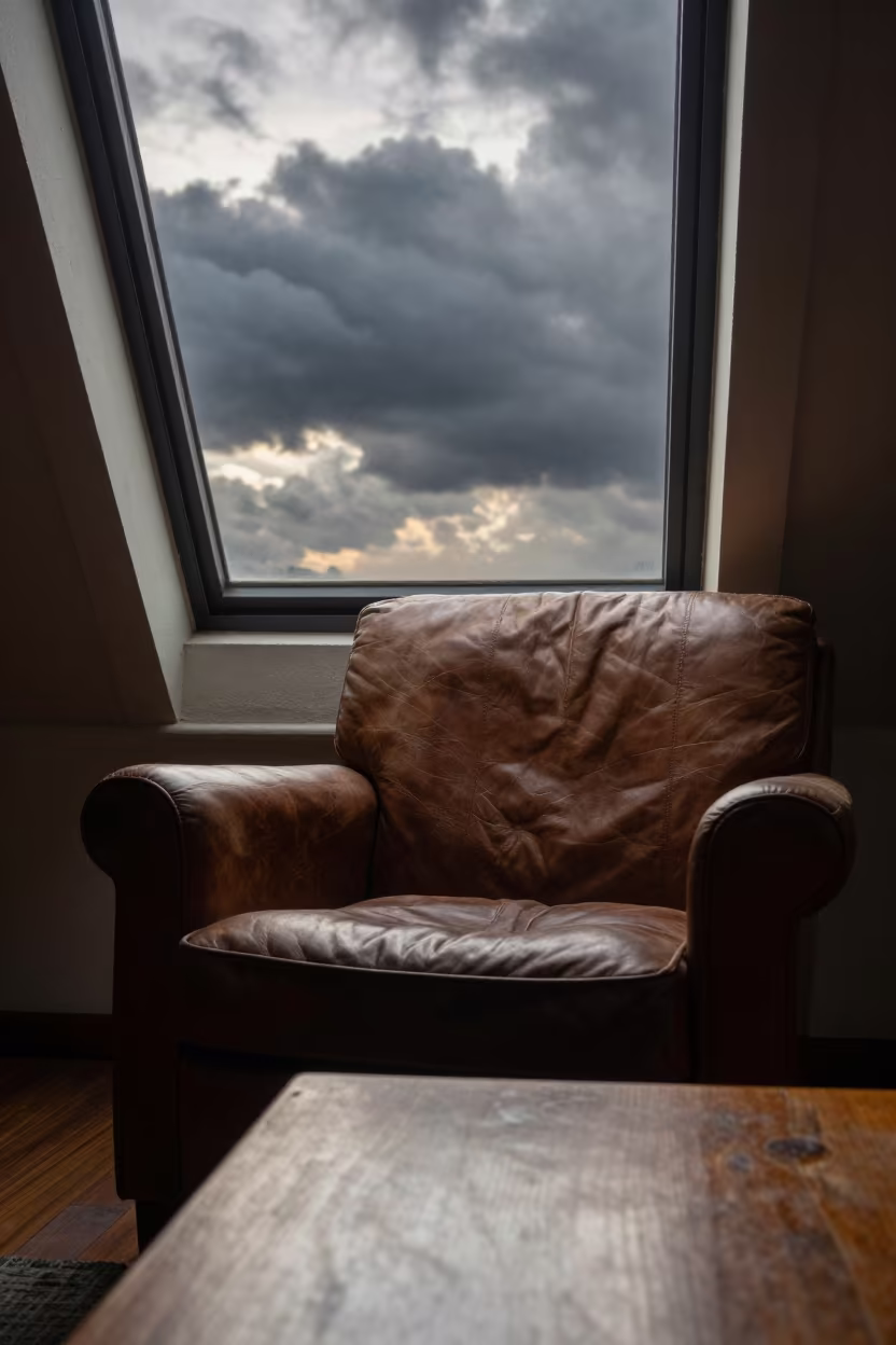 Thunderstorm View from Kaohsiung Attic Chair in on a worn leather armchair in Kaohsiung