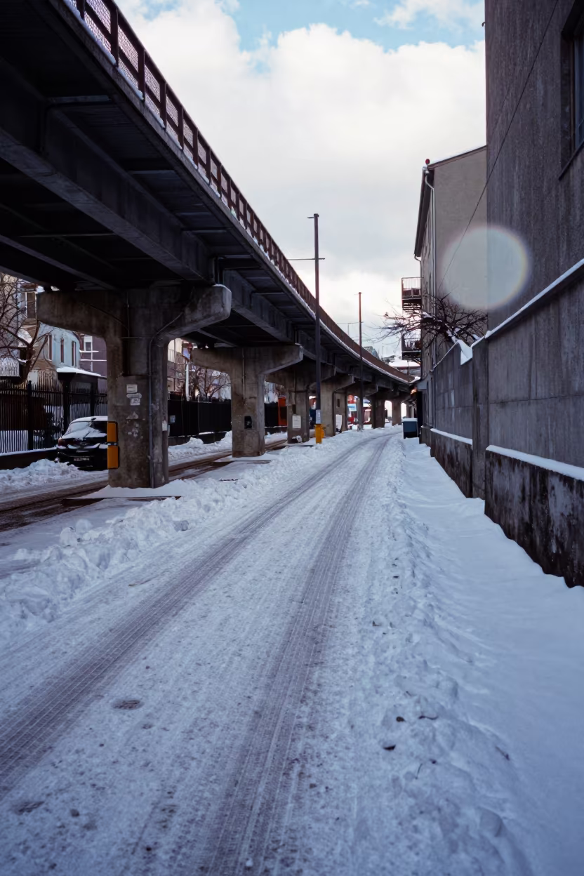 Tire Tracks in Fresh Snow Oslo Alley in under an elevated train line in Oslo