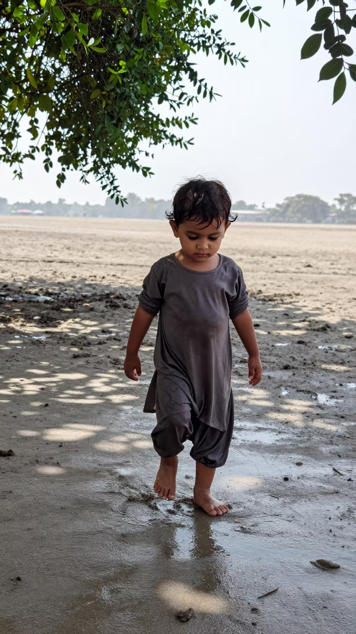 Toddler Walking Barefoot Wet Sand Monsoon in near Sheikhupura