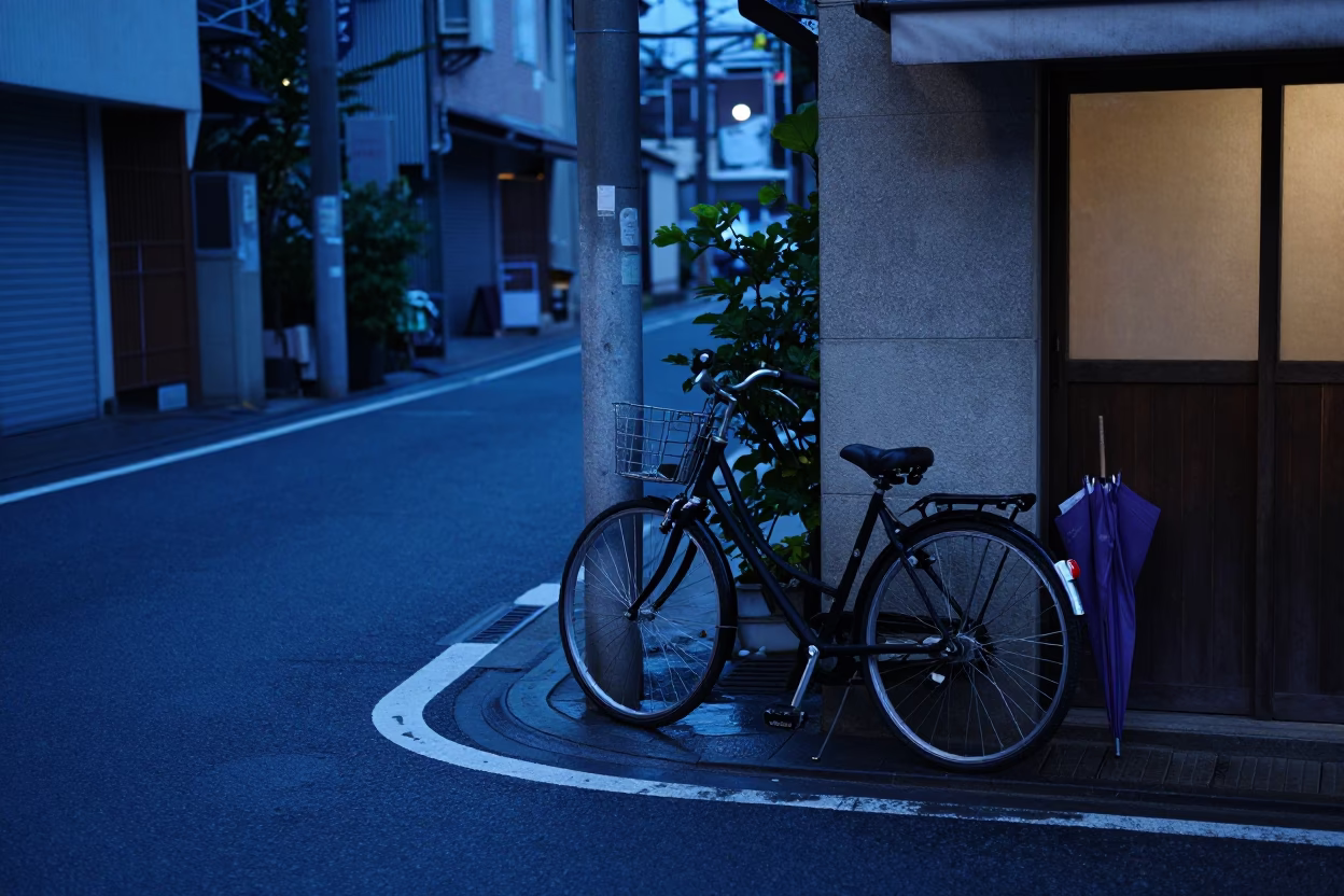 Tokyo blue hour street scene with parked bicycle and closed umbrellas in in Tokyo, Japan
