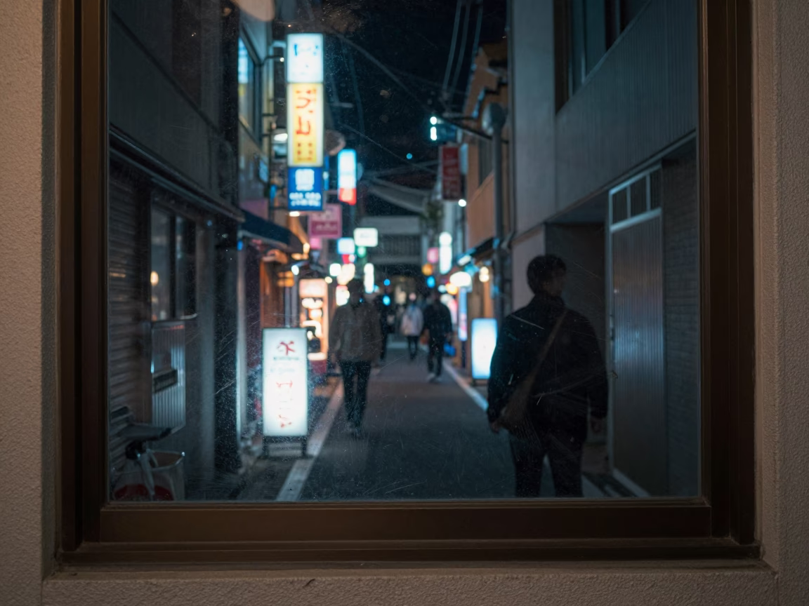 Tokyo Night Street Scene with Paint Flecks on Window Glass and Polished Brass Rail in in Tokyo, Japan