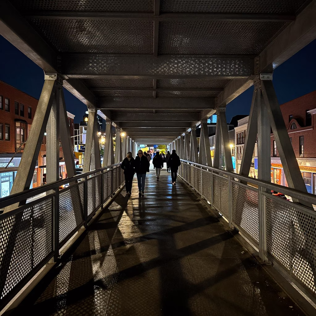 Toronto Night Pedestrian Overpass with Perforated Metal and Wet Footsteps Under Deep Sky in in Toronto, Ontario, Canada