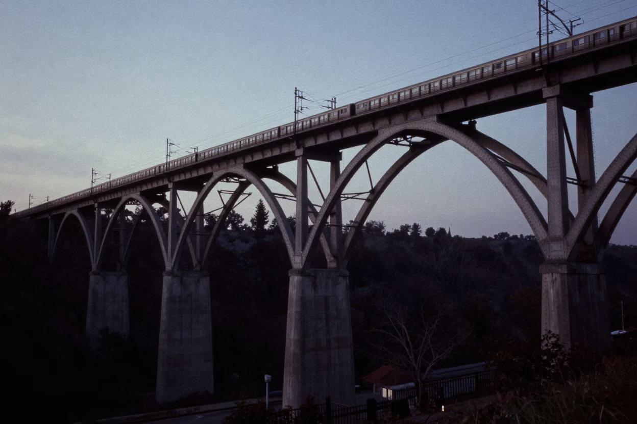 Toronto Railway Viaduct Arches Passing Train in Predawn Darkness in in Toronto, Ontario, Canada