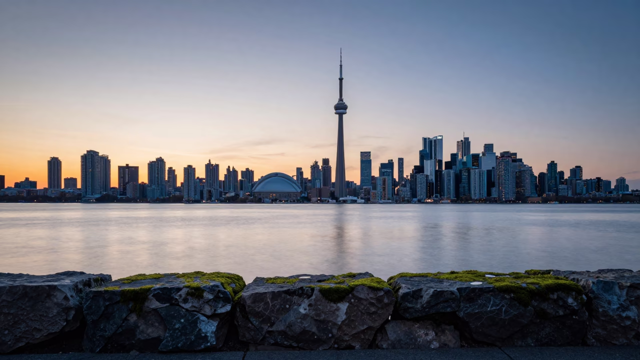 Toronto Skyline at Nautical Dawn with Mossy Stone Wall and Urban Riverbank View in in Toronto, Ontario, Canada