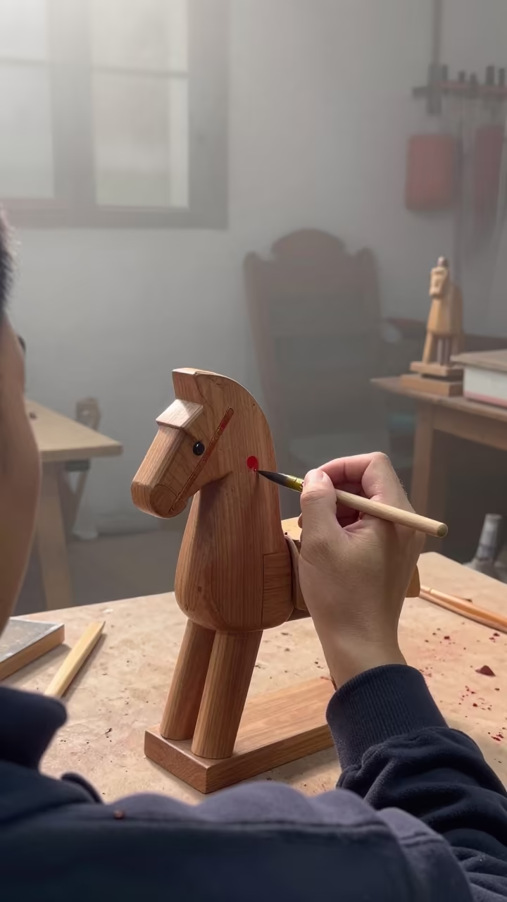 Toymaker Painting Wooden Horse in Ningbo in in the old quarter in Ningbo
