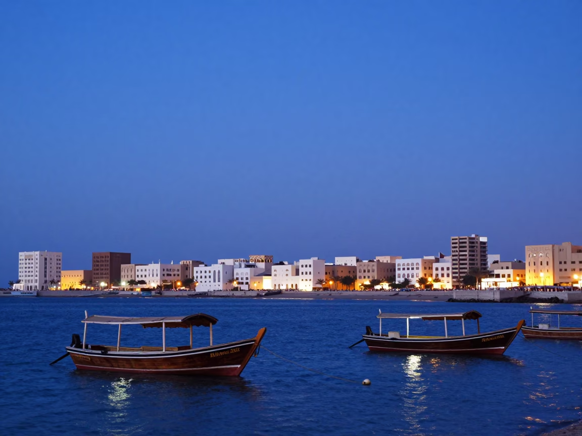 Traditional Dhow Boats And Coastal City Lights in Muscat in in Muscat, Oman