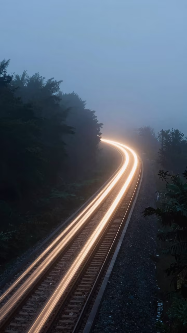 Train Light Trail on Misty Causeway at Dawn in on a wind-open causeway near Balkanabat