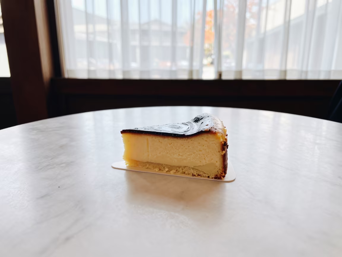 Tres Leches Cake Slice on Marble Table in on a marble cafe table in Takayama