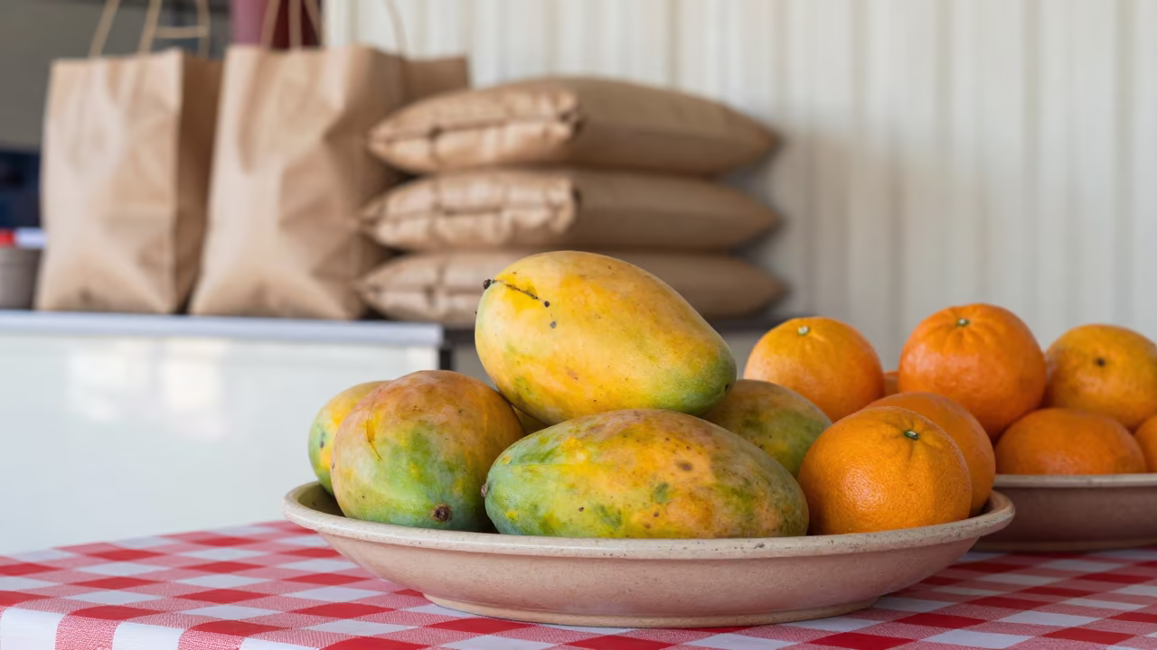 Tropical Fruit Bowl on Checkered Cloth Krabi in on a grocer's counter with stacked paper sacks in Krabi