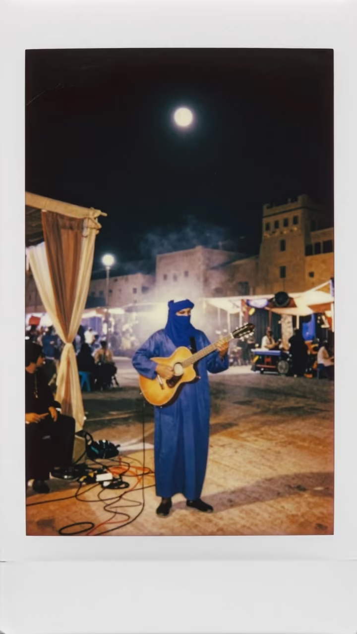 Tuareg Guitarist Under Moon Sky in Cairo Street in at a street corner busking spot in Cairo