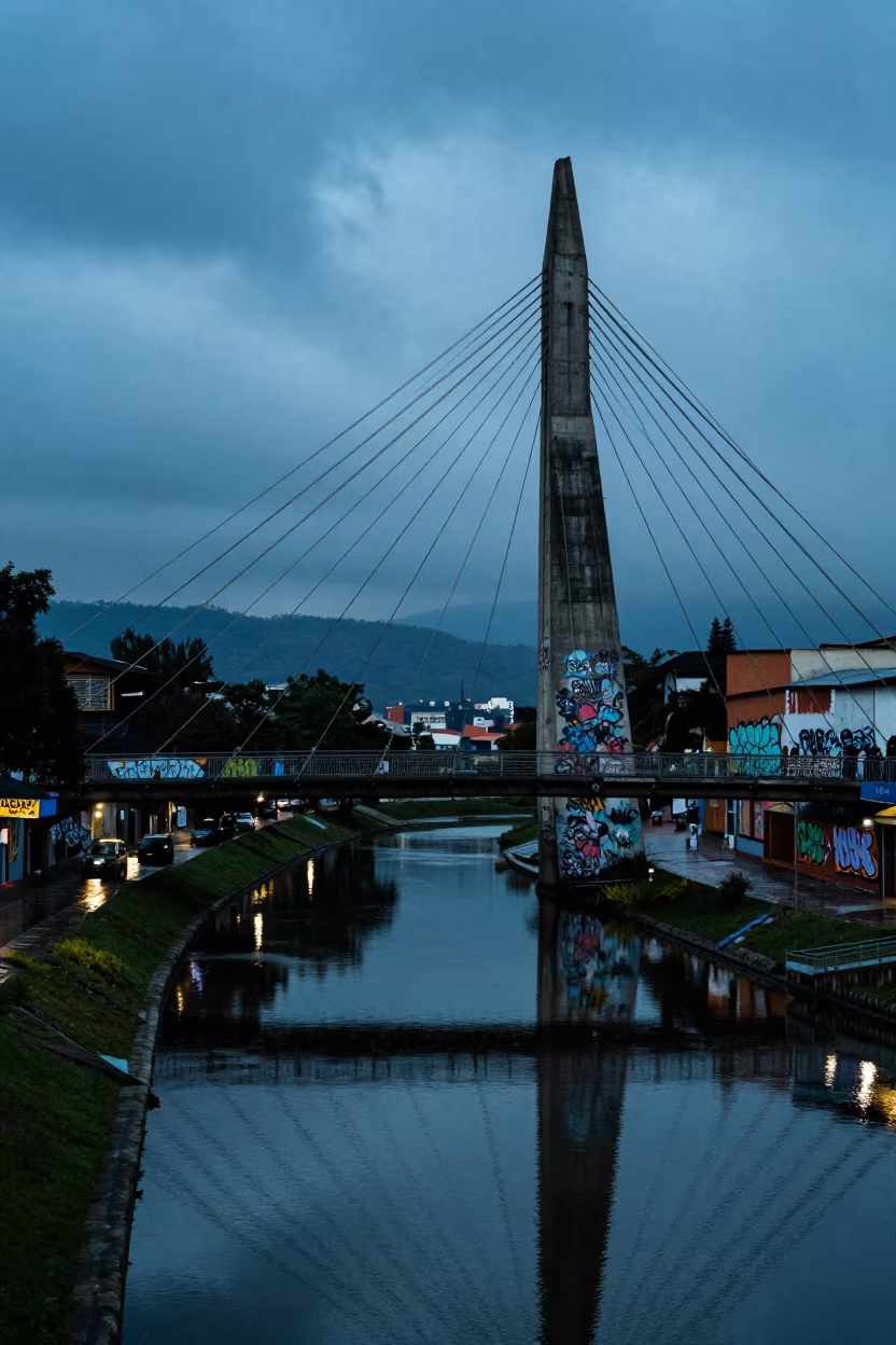 Twilight Bridge Cables Over Bogota Canal in beside a canal-front facade in Graffiti District, Bogota
